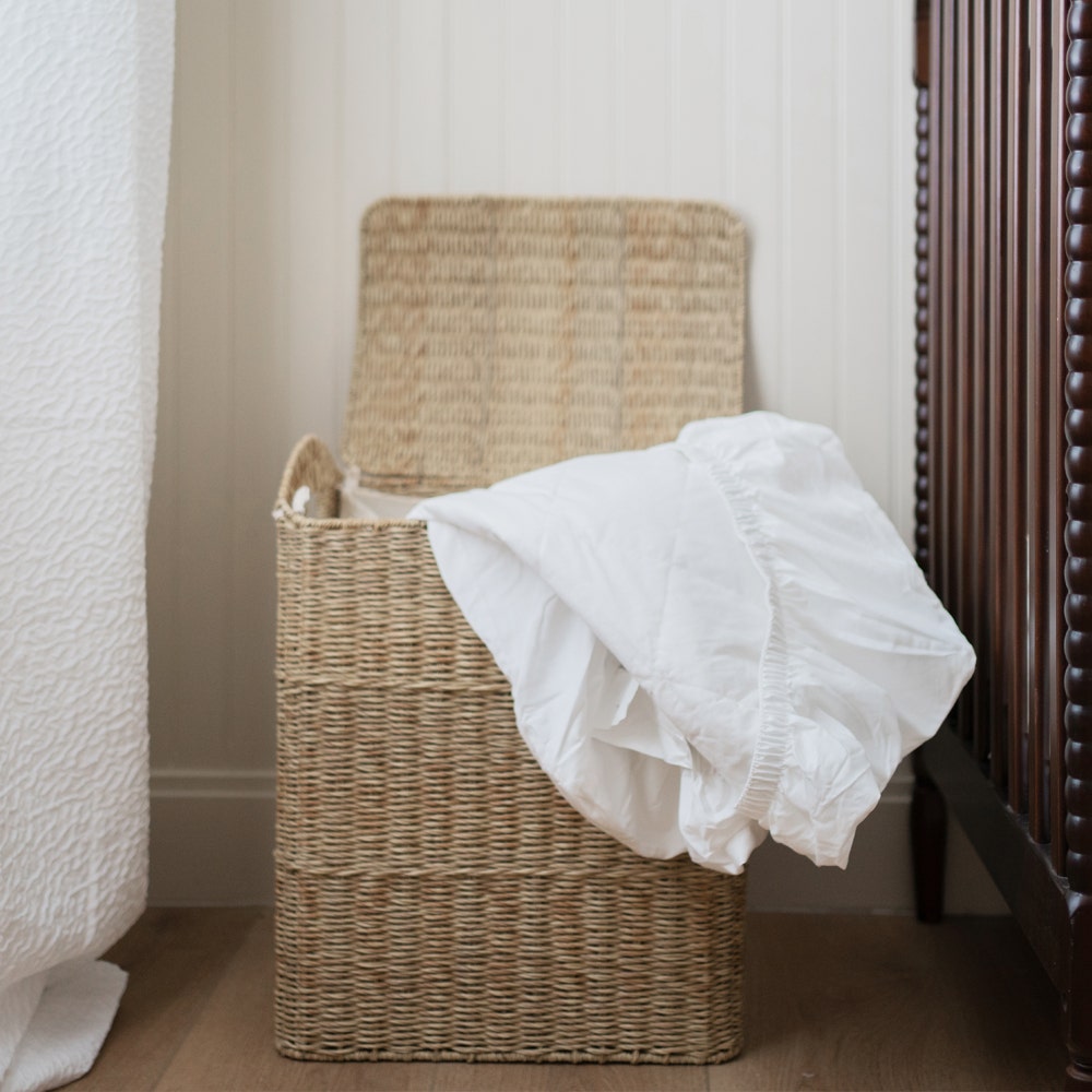 Quilted Organic Mattress Pad Protector in Laundry Basket