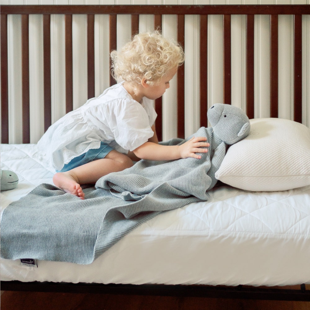 Toddler Putting Bear to Bed