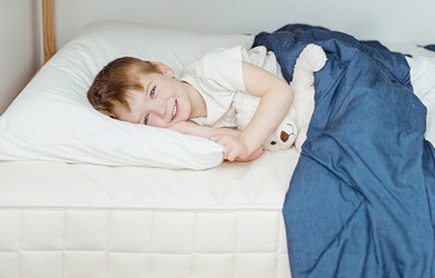 Young child resting on a twin bed